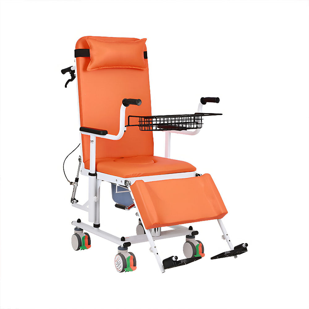 Orange upholstered patient transfer chair with high headrest, padded armrests, wire storage basket, extended leg rest, commode bucket under the seat and six colour-coded locking casters, on a white background