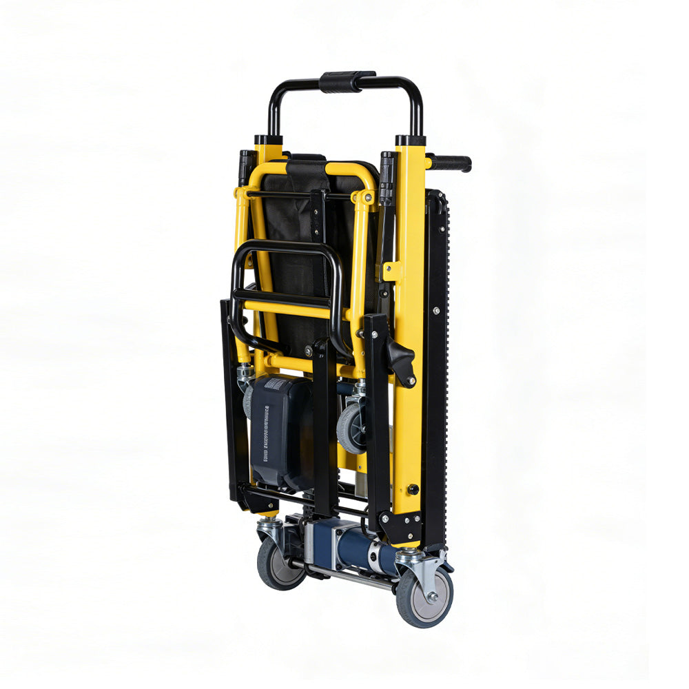 Yellow and black stair climbing wheelchair shown folded upright with the rubber track, battery pack and pull handle visible, on a white background