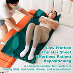 Caregiver sliding a reclining woman across a bed using the green low-friction transfer sheet, with the orange transfer chair reclined flat alongside the mattress